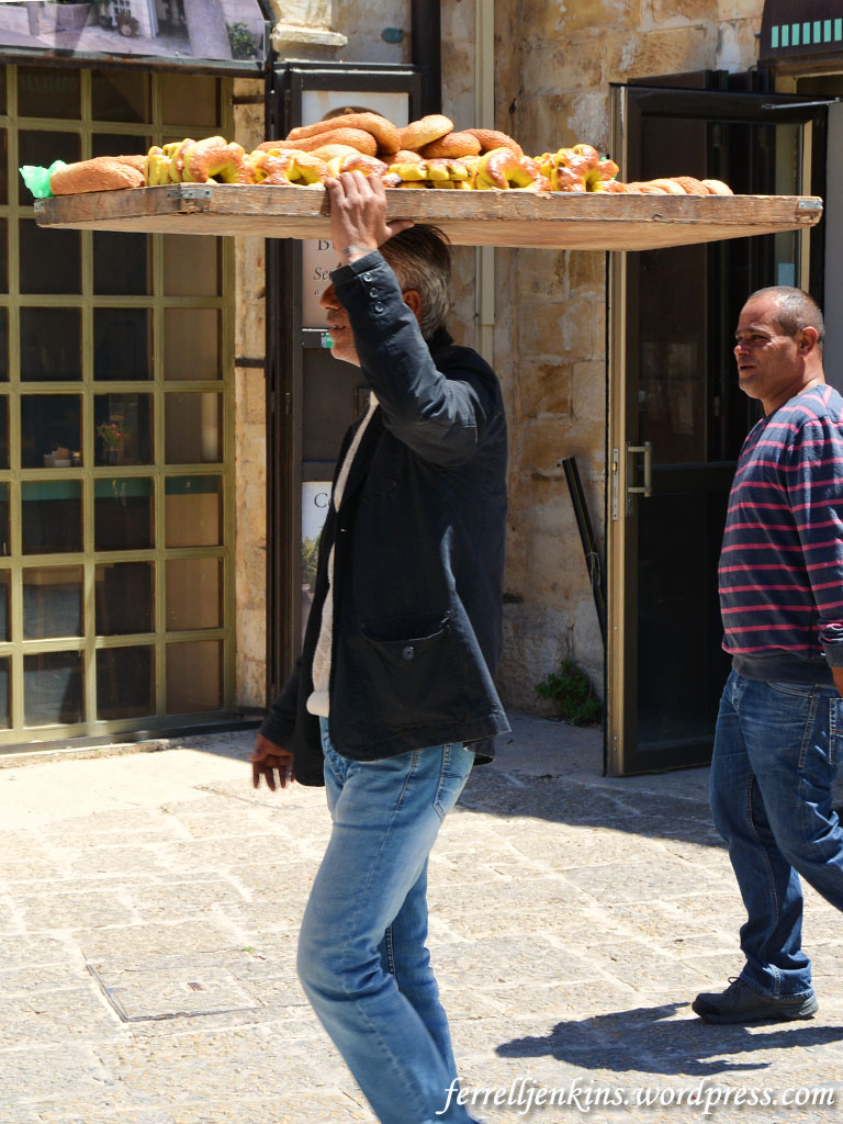 Man carrying bread on his head in the Muristan area of the Old City of Jerusalem. Photo by Ferrell Jenkins.